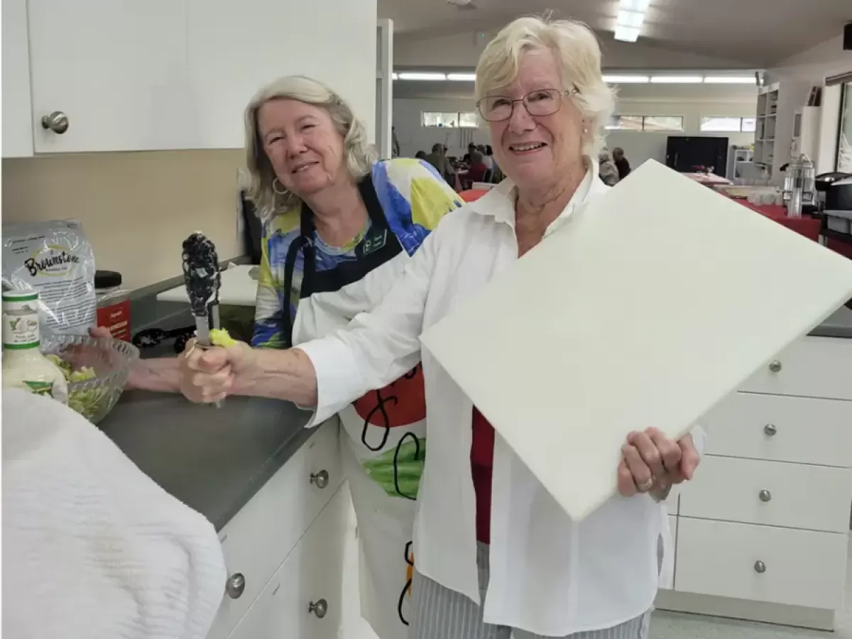 Ladies getting things prepared in the kitchen.