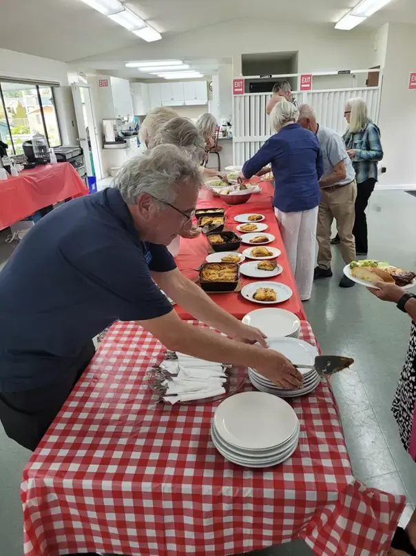 Handing out plates of lasagna at the club.