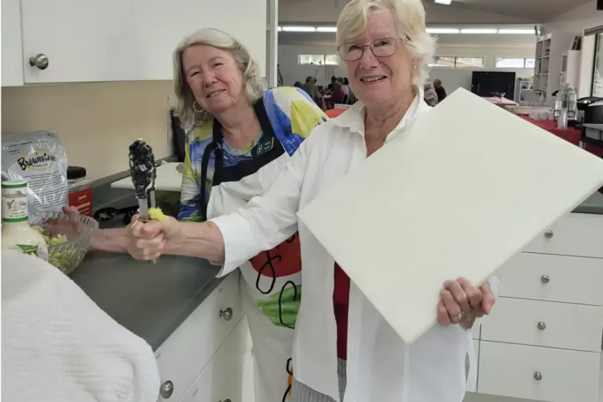Ladies getting things prepared in the kitchen.