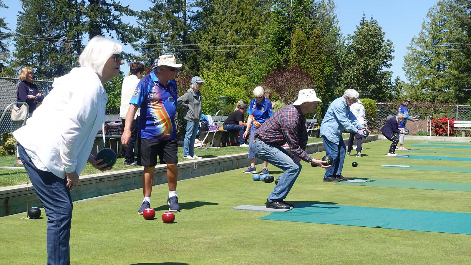 Several outdoor lawn bowling games happening at once